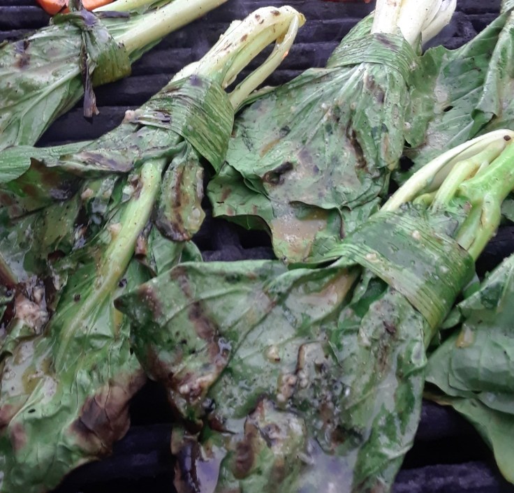 pak choi tied with garlic scapes