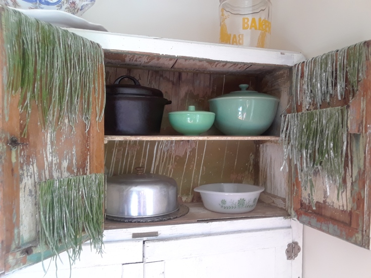 green pasta drying on cabinet