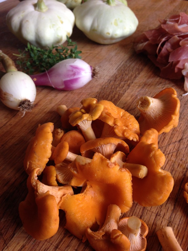 chanterelle pattypan squash and proscuiutto on butcher block