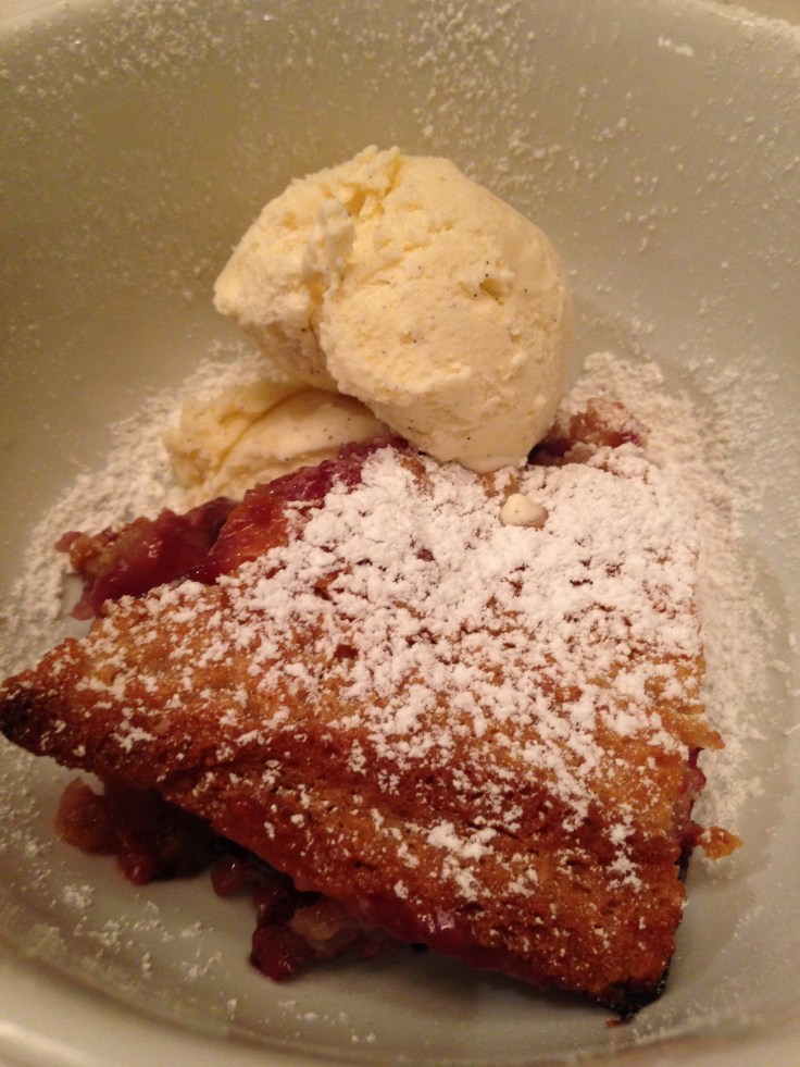 Berry Cobbler with ice cream and powdered sugar
